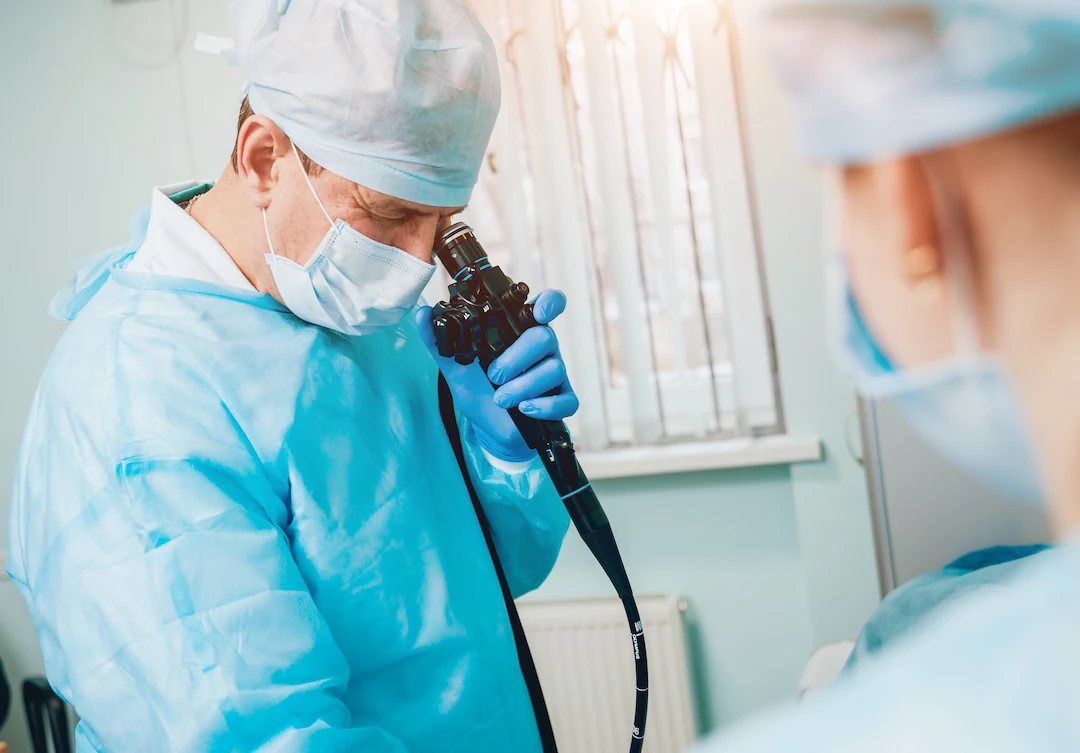 Doctor looking through endoscope