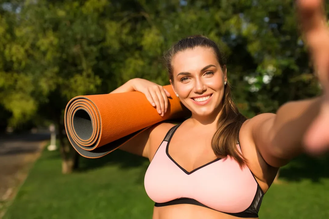 Active woman carrying yoga mat