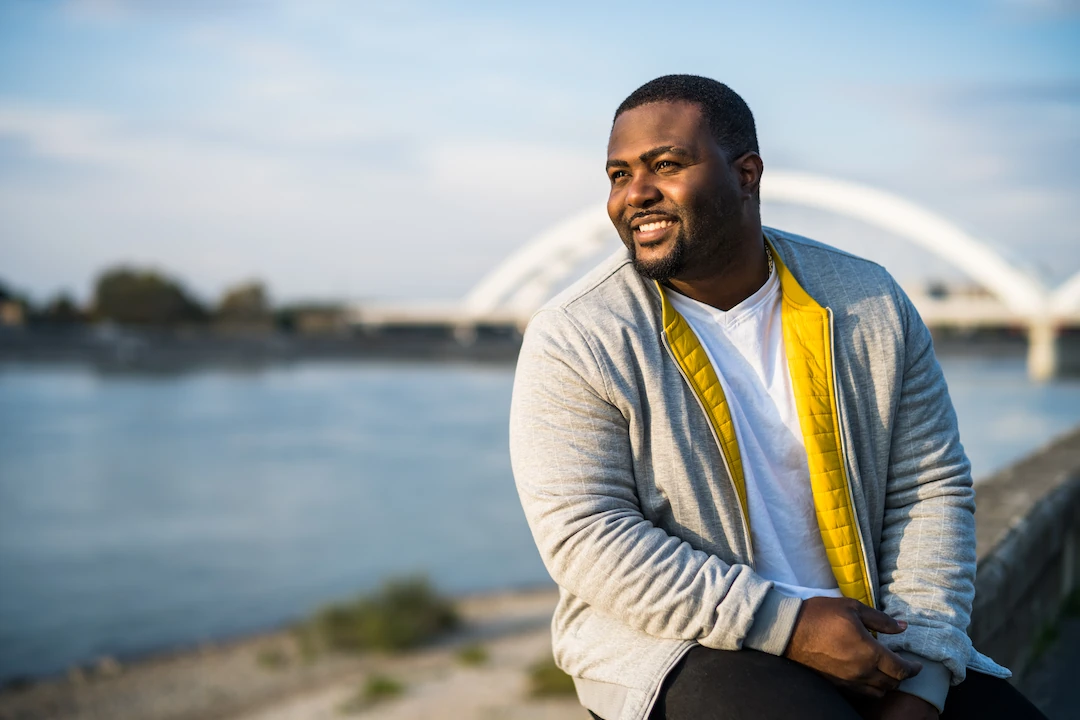 Heavy young man resting by the river
