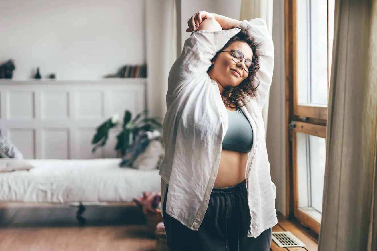 Young plus size woman stretching