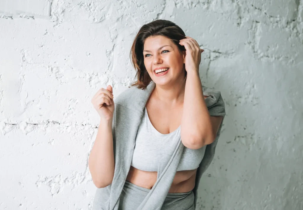 Cheerful plus size woman in comfortable sports wear